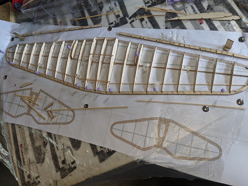 Don't try ti figure it out from this picture.  Hint: except for the three ribs in the center and the wing tips nothing in this picture has glue on it.